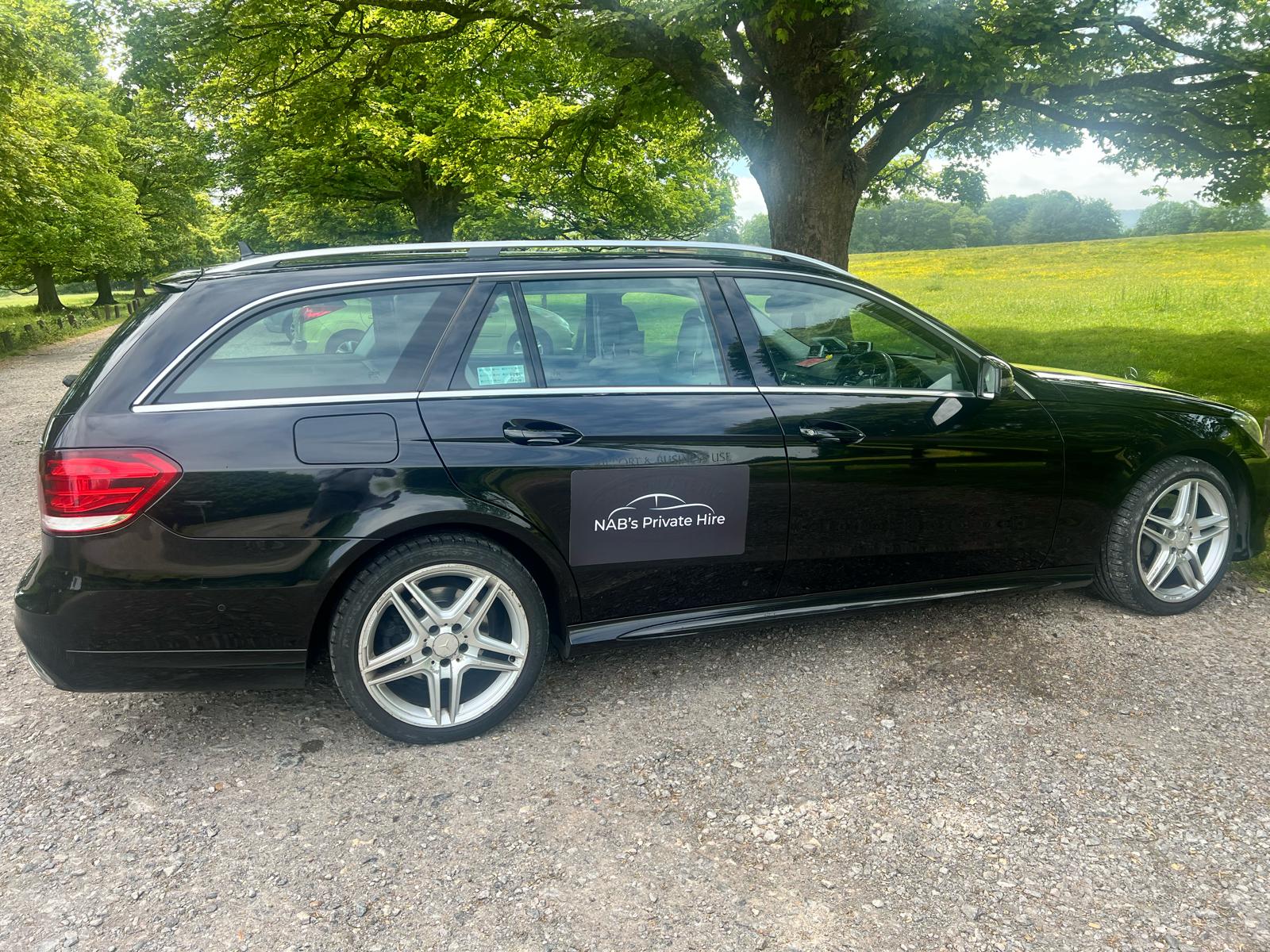NABs Private Hire black Mercedes-Benz E-Class E350 at sunrise under English oak
